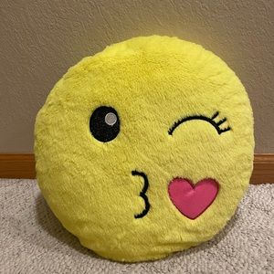 Justice winking and blowing kiss emoji pillow.